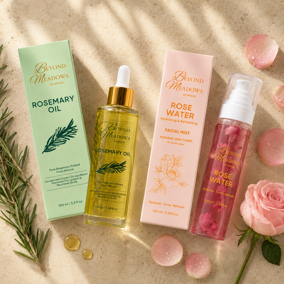Beyond Meadows rose water and rosemary oil laid out together with their cartons, fresh rose petals and sprigs of rosemary.